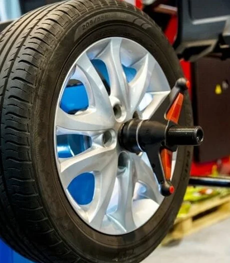 Coastal Tyre Services' wheel balancing machine calibrating a car tire.