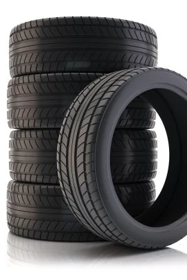 Stack of five new car tires from Coastal Tyre Services isolated on a white background.